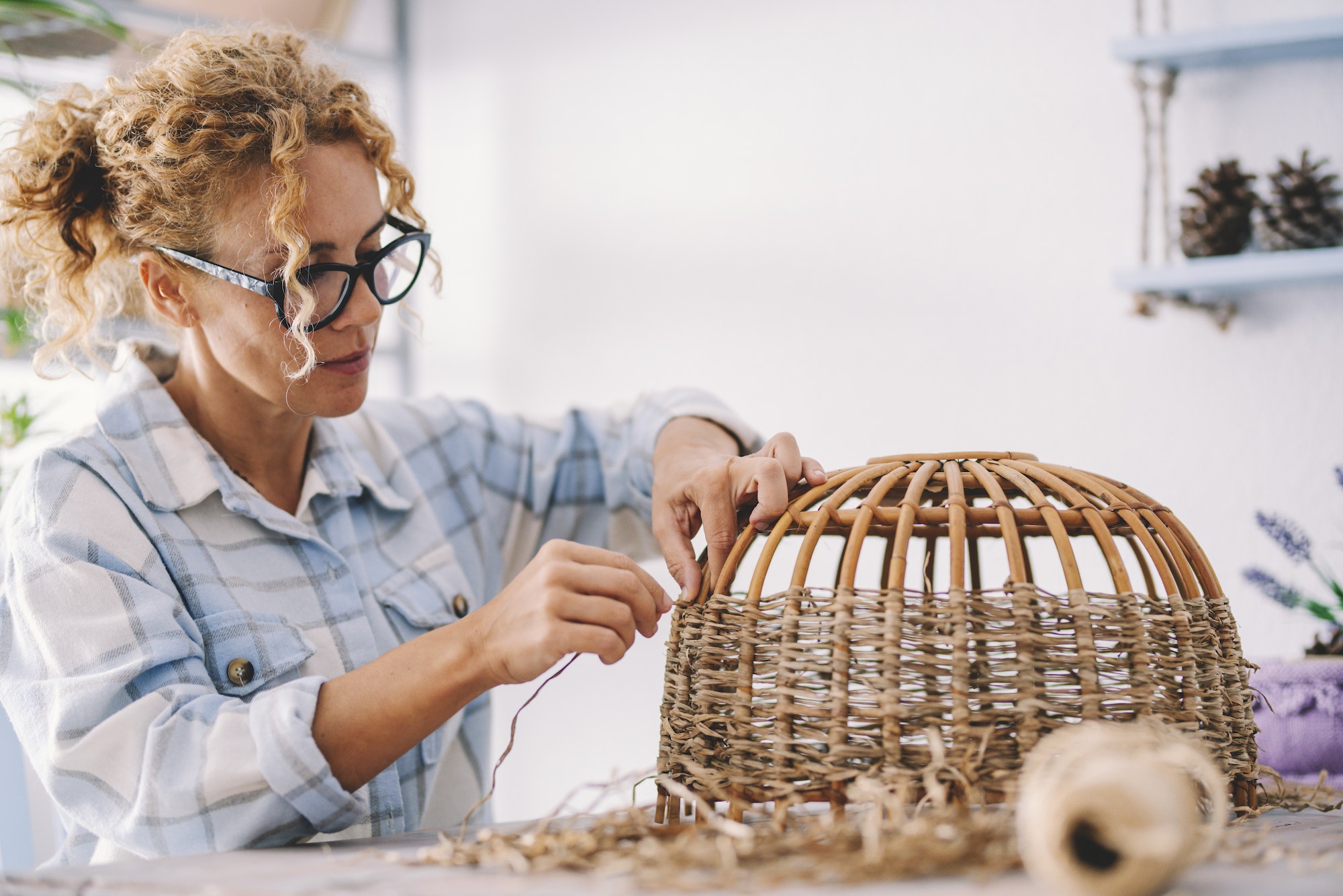 Creative handwork at home in indoor hobby leisure activity for female people realizing wicker lamp