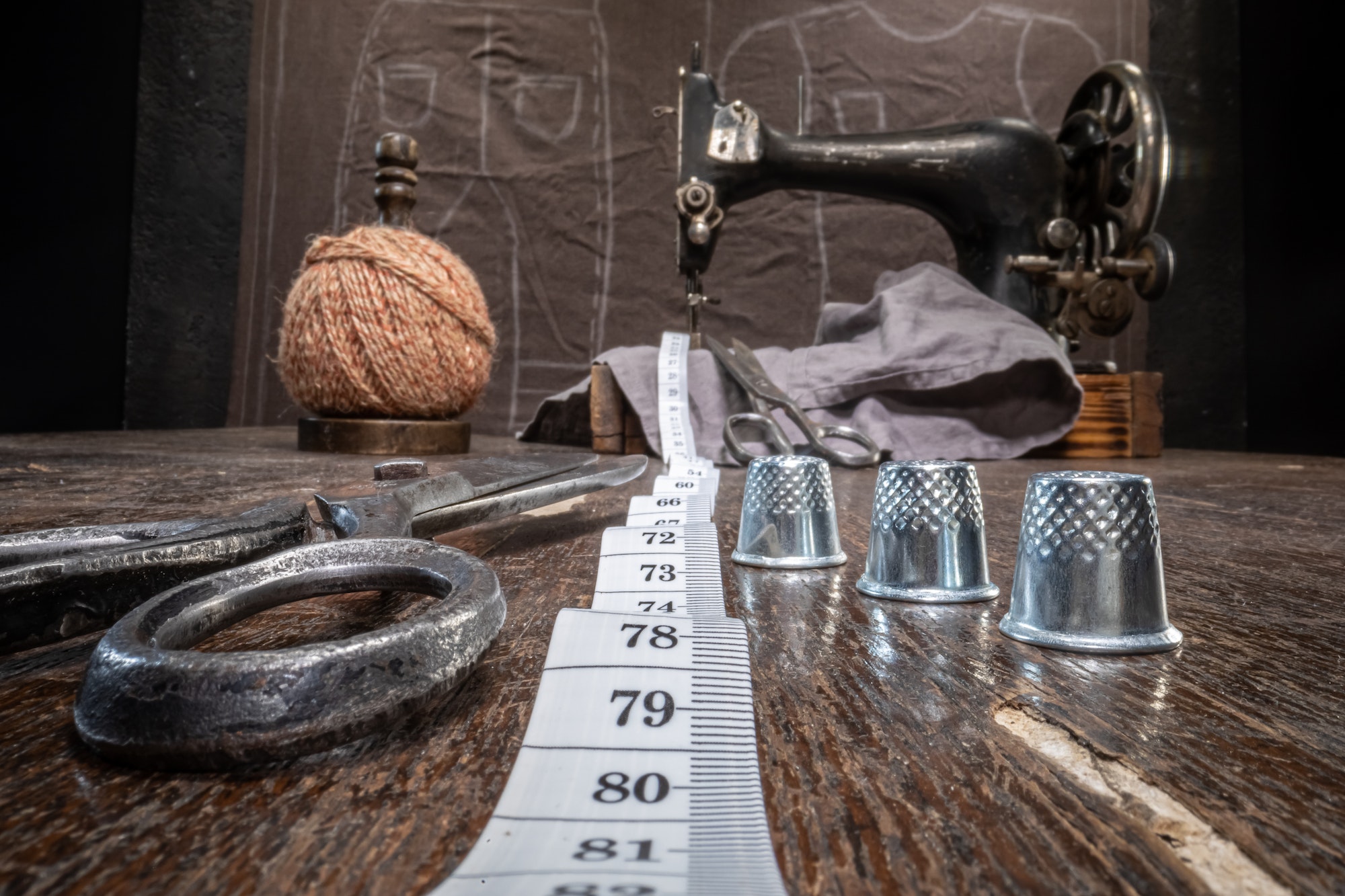 Old tailor workshop with scissors and sewing machine.